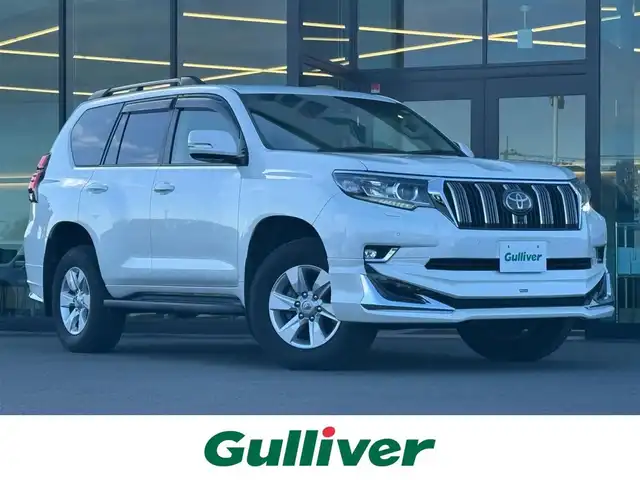 トヨタ ランドクルーザー プラド TX Lパッケージ 東京都 2019(平31)年 1.5万km ホワイトパールクリスタルシャイン セーフティセンス/プリクラッシュセーフティ/レーントレーシングアシスト/オートハイビーム/ブラインドスポットモニター/レーダークルーズ/純正メーカーナビ/CD/DVD/BT/AM/FM/TV/バックカメラ/LEDヘッドライト/フォグ/サンルーフ/ルーフレール/モデリスタエアロ/レザーシート（ベージュ）/シートヒーター/ベンチレーション/ビルトインETC2.0