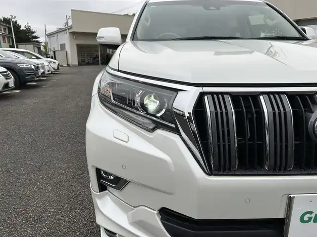 トヨタ ランドクルーザー プラド TX Lパッケージ 宮城県 2020(令2)年 6.5万km ホワイトパールクリスタルシャイン 装備/ベージュ内装/サンルーフ/ＴＲＤ前後エアロ/純正ナビ/(AM、FM、CD、DVD、フルセグTV、SD、BT、USB)/純正エンジンスターター×１/スペアキー×１/ＴＶキャンセラー/３列シート/ウッドステアリング/プッシュスタートボタン/ドアバイザー/機能/寒冷地仕様/レーダークルーズコントロール/レーンキープアシスト/シートヒーターD、N/シートクーラーD、N/パワーシートD、N/横滑り防止/2ndSTARTボタン/四駆切り替えボタン/オフロード切り替えボタン/リアフォグインジケーター/オートライト/アイドルアップ