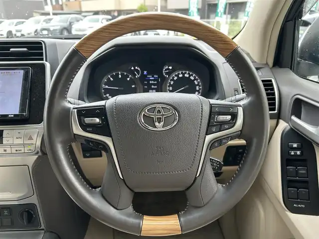 トヨタ ランドクルーザー プラド TX Lパッケージ 宮城県 2020(令2)年 6.5万km ホワイトパールクリスタルシャイン 装備/ベージュ内装/サンルーフ/ＴＲＤ前後エアロ/純正ナビ/(AM、FM、CD、DVD、フルセグTV、SD、BT、USB)/純正エンジンスターター×１/スペアキー×１/ＴＶキャンセラー/３列シート/ウッドステアリング/プッシュスタートボタン/ドアバイザー/機能/寒冷地仕様/レーダークルーズコントロール/レーンキープアシスト/シートヒーターD、N/シートクーラーD、N/パワーシートD、N/横滑り防止/2ndSTARTボタン/四駆切り替えボタン/オフロード切り替えボタン/リアフォグインジケーター/オートライト/アイドルアップ
