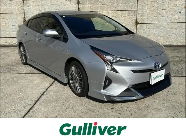 トヨタ プリウス E 長崎県 2016(平28)年 9.7万km シルバーM 社外メモリナビ/（CD/DVD/BT/フルセグ）/バックカメラ/社外エアロ（F/S/R下）/オートライト/ETC/スマートキー/プッシュスタート/社外17インチAW