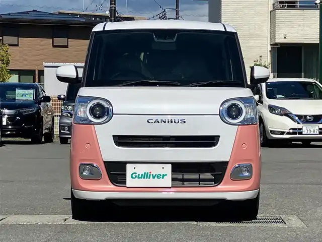 ダイハツ ムーヴ キャンバス ストライプス G 静岡県 2024(令6)年 0.1千km シャイニングホワイトパール/アプリコットピンクメタリック 純正ナビ(CD/DVD/BT/フルセグ)/バックカメラ/登録済未使用車/エンジンスタートボタン/保証書/取扱説明書/パワーステアリング/パワーウィンドウ/アイドリングストップ/オートエアコン/スペアキー１本/USB入力端子/D席N席シートヒーター/両側パワースライドドア/ABS/横滑り防止装置/コーナーセンサー前後/レーンキープアシスト/盗難防止装置/オートライト/オートマチックハイビーム/LEDヘッドライト/W+サイドエアバック/カーテンエアバック/衝突軽減システム/カップヒーター
