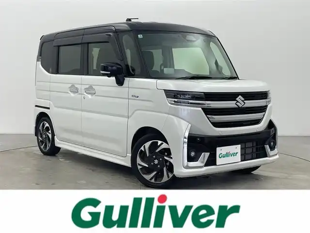 スズキ スペーシア カスタム HYBRID XS 富山県 2025(令7)年 0.8万km ピュアホワイトパール/ブラック2トーン 純正ナビ（AM/FM/BT/USB/フルセグ）/全方位カメラ/ドライブレコーダー/ETC/両側パワースライドドア/ハーフレザーシート/シートヒーター/ハンドルヒーター/衝突被害軽減システム/レーダークルーズコントロール/レーンキープアシスト/コーナーセンサー/横滑り防止装置/ヘッドアップディスプレイ/オートホールド付電子パーキング/純正アルミホイール/純正フロアマット/ハンドルヒーター/革巻きステアリング/ステアリングスイッチ/オートLEDライト/フォグライト/スマートキー