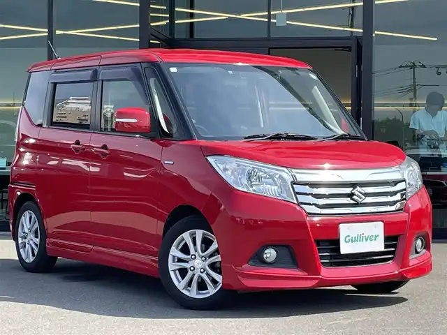 スズキ ソリオ HV MZ Dカメラ ブレーキS 東京都 2016(平28)年 7.5万km ファーベントレッド 純正7インチナビ/フルセグTV/Bluetooth/CD/DVD/両側パワースライドドア/バックカメラ/デュアルカメラブレーキサポート/・前方衝突軽減システム/・誤発進抑制/・車線逸脱警報/・ふらつき警報/・先行車発進お知らせ/・エマージェンシーストップシグナル/・クルーズコントロール/後席ロールサンシェード/運転席シートヒーター/オートライト/ETC/ドライブレコーダー(HDR-102)/フロントフォグランプ/革巻きステアリングホイール/ステアリングスイッチ/オートエアコン/純正15インチアルミホイール/ダブル＋サイドエアバッグ/アイドリングストップ/保証書/取扱説明書/プッシュスタート