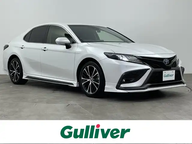 トヨタ カムリ WSレザーパッケージ 大分県 2021(令3)年 7万km プラチナホワイトパールマイカ ワンオーナー/GRエアロ（F、S、R）/TRDマフラー/TOYOTAセーフティセンス/・プリクラッシュセーフティ/・レーントレーシングアシスト/・レーダークルーズコントロール/・オートマチックハイビーム/ブラインドスポットモニター/リアクロストラフィックアラート/ヘッドアップディスプレイ/JBLサウンドシステム/9型ディスプレイオーディオ/・ナビ機能有り、フルセグTV、USB/・CD/DVD、BT対応/・AppleCarPlay、AndroidAuto/ステアリングスイッチ/バックカメラ/黒革シート/・前席パワーシート/前席シートヒーター/ビルトインETC/社外ドライブレコーダー（前、後、車内）/横滑り防止装置/電動格納ミラー/純正フロアマット/オートライト/LEDヘッドライト/LEDフォグ/純正18インチアルミホイール/クリアランスソナー /保証書、取説、スペアキー