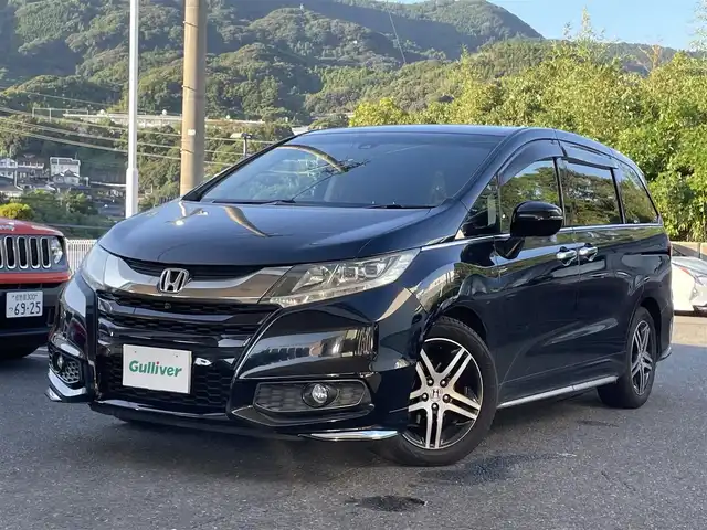 ホンダ オデッセイ アブソルート アドバンス 長崎県 2015(平27)年 14.7万km クリスタルブラックパール ワンオーナー車/メーカーインターナビ/（フルセグ、CD、DVD、AM、FM、BTオーディオ）/バックカメラ/全周囲カメラ/プッシュスタート/WAC/アダプティブクルーズコントロール/パドルシフト/レーンキープアシスト/ステアリングリモコン/オートライト/両側パワースライドドア/ビルトインETC/ハーフレザー/D席パワーシート/オールオートパワーウィンドウ/電格ウィンカーミラー/2列目ドアサンシェード/フリップダウンモニター/衝突軽減システム/横滑り防止/アイドリングストップ/路外逸脱抑制システム/Wエアバッグ/カーテンエアバッグ/ABS/ナビ取扱説明書/取扱説明書/保証書/スペアキー×１