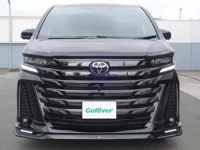 トヨタ ヴェルファイア Z プレミア 静岡県 2024(令6)年 0.1万km ブラック ＜Zプレミア　GRパーツ多数＞/　GRフロントスポイラー/　GRサイドスカート/　GRリヤバンパースポイラー/　GRドレスアップマフラー/メーカーOP デジタルインナーミラー/ワンオーナー・禁煙車/　走行485ｋｍ/セーフティーセンス/BSM/　プリクラッシュ　レーンチェンジ/　レーントレーシング　レーンデュパーチャー/　全車速追従レーダークルーズ/　アダプティブファイビーム/　ロードサインアシスト/　プロアクティブドライビングアシスト/　発信遅れ告知機能/トヨタチームメイト/3眼LEDヘッドライト・フォグ/左右独立ムーンルーフ/14インチディスプレイオーディオプラス/　コネクチッドナビ/　10スピーカー　チデジ　USB HDMI/　アップルカープレイ　アンドロイドオート/12.3インチTFTカラーメーター/カラーヘッドアップディスプレイ/パワーシート前席/　D席マイコンプリセットドライビングポジション/2列目エグゼクティブパワーシート/　パワーサンシェード/スマートキー2個/カロ調フロアマット/保証書