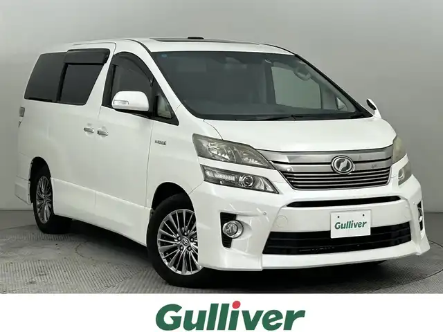 トヨタ ヴェルファイア ハイブリット ZR Gエディション 道央・札幌 2012(平24)年 11.1万km ホワイトパールクリスタルシャイン ・４WD/・純正8インチHDDナビ/　BT/CD/USB/HDD/フルセグ/・純正11インチフリップダウン/・純正ビルトインETC/・バックカメラ/・レーダークルーズコントロール/・衝突軽減ブレーキ/・レーンキープアシスト/・横滑り防止/・両側パワースライドドア/・電動リアゲート/・サンルーフ/・前席シートヒーター/・前席パワーシート/・社外フロアマット/・純正サマー17インチAW/・プッシュスタート/・スマートキー/・オートライト/・フロントフォグライト/・取扱説明書/・保証書