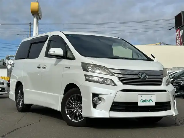 トヨタ ヴェルファイア ハイブリット ZR Gエディション 道東・釧路十勝 2012(平24)年 11.1万km ホワイトパールクリスタルシャイン 4WD/純正ナビ/（CD/DVD/BT）/フルセグTV/バックカメラ/フリップダウンモニター/サンルーフ/両側パワースライドドア/電動リアゲート/クルーズコントロール/パワーシート(全席)/ヒートシーター（前席）/メモリシート/オットマン/レーダー探知機/電動格納ミラー/ウィンカーミラー/100V電源/スマートキー/スペアキー/社外エンジンスターター/ステアリングスイッチ/ビルトインETC/前後コーナーセンサー/横滑り防止装置/AFS/衝突軽減