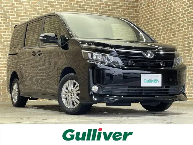 トヨタ ヴォクシー V 岩手県 2016(平28)年 8万km ブラック ワンオーナー/４WD/寒冷地仕様/ALPINE後席モニター/ALPINEビッグX10インチナビ/両側パワースライドドア/トヨタセーフティセンスC/プリクラッシュセーフティ/レーンディパーチャーアラート/オートマチックハイビーム/先行車発進お知らせ機能/MTモード付AT/横滑り防止装置/アイドリングストップ/ウインドシールドデアイサー/ロールサンシェード/ウォークスルー/フルセグTV/バックカメラ/ETC/リヤオートエアコン/LEDヘッドランプ/純正１５インチアルミホイール