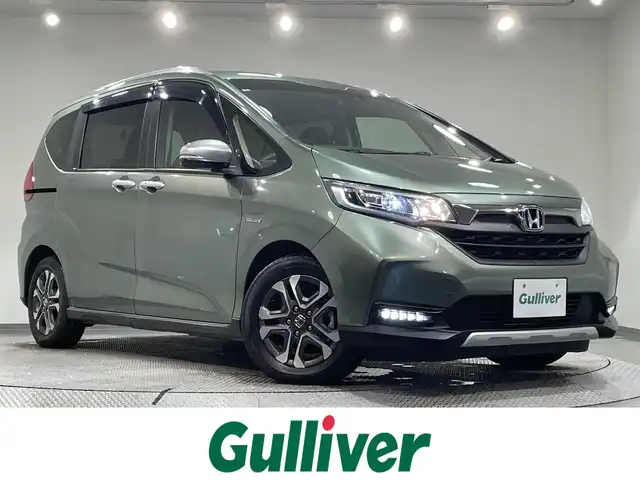 ホンダ フリード ハイブリット クロスター ホンダセンシング 愛知県 2021(令3)年 3.4万km シルバーミストグリーンM 純正ナビ　/（Bluetooth/FM/AM/SD/CD・DVD再生/地デジ/iPod)/両側パワースライドドア　/ホンダセンシング/　　-レーダークルーズコントロール　/　　-衝突軽減ブレーキ　/　　-車線逸脱警報/　　-先行車発進お知らせ機能/　　-標識認識機能/シートヒーター　/ビルトインＥＴＣ　/ＬＥＤヘッドライト　/バックカメラ　/前後ドライブレコーダー　/純正フロアマット　/ＬＥＤフォグランプ/プッシュスタート/　　-スマートキー