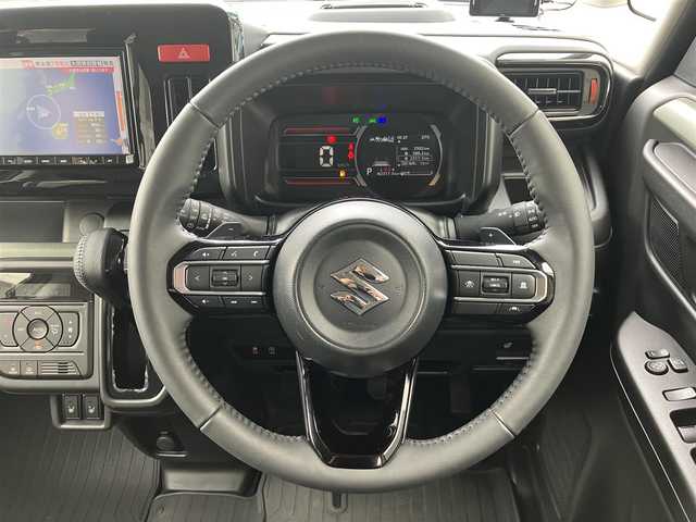 スズキ スペーシア ギア HYBRID XZターボ 埼玉県 2025(令7)年 0.3万km オフブルーメタリック/ガンメタリック2トーンルーフ ワンオーナー/衝突被害軽減ブレーキ/レーダークルーズコントロール/前後コーナーセンサー/バックカメラ/純正ナビ・オーディオ/Panasonic：CN-HZ8A5/（フルセグTV/BT/CD/DVD/FM/AM）/前後ドラレコ/レーダー探知機/ヘッドアップディスプレイ/両側パワースライドドア/ビルトンETC/前席シートヒーター/ステアリングヒーター/ステアリングリモコン/パドルシフト/革巻きステアリング/後席オットマン/後席サンシェード/ヘッドアップディスプレイ/USBポート×4/フォグライト/スマートキー（スペアキーあり）/車両取説、ナビ取説、メンテナンスノートあり/プッシュスタート/アイドリングストップ