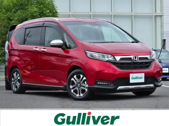 ホンダ フリード ハイブリット クロスター ホンダセンシング 鹿児島県 2021(令3)年 2.4万km プレミアムクリスタルレッドM 両側パワースライドドア　/アダプティブクルーズコントロール　/ビルトインＥＴＣ　/前後純正ドライブレコーダー　/純正メモリーナビ（ＶＸＭ－２２４ＶＦｉ）　/Ｄ＋Ｎ席シートヒーター　/ルーフレール　/ＢＴオーディオ/ホンダセンシング/横滑り防止装置/レーンキープアシスト/バックカメラ/プッシュスタート/スマートキー/純正アルミホイール(15インチ)/プッシュスタート/スマートキー/エアバッグ(W＋サイド)/カーテンエアバッグ