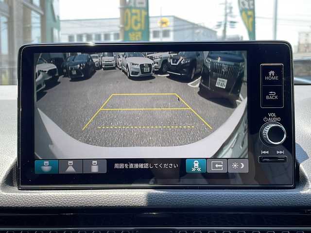 ホンダ シビック e:HEV 福岡県 2022(令4)年 1.4万km チャンピオンシップホワイト 純正ナビ（Ｂｌｏｏｔｏｏｔｈ・フルセグTV・ラジオ）　/クルーズコントロール/ＥＴＣ　/前席パワーシート　/前席シートヒーター/前後ドライブレコーダー　/ワイヤレス充電器　/BOSEプレミアムサウンド/スイッチ式シフト/ＵＳＢポート×２/MTモード付AT車/ハーフレザーシート/クリアランスソナー/レーンキープアシスト/横滑り防止装置/カーテンエアバッグ/スマートキー/保証書/取扱説明書