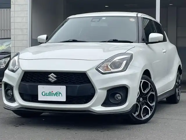 スズキ スイフト スポーツ 道央・札幌 2023(令5)年 1.8万km ピュアホワイトP ・ワンオーナー/・衝突軽減ブレーキ/・純正ナビ/　CD＆DVD＆BT＆TV/・バックカメラ/・ブランドスポットモニター/・レーダークルーズコントロール/・コーナーセンサー/・レーンキープアシスト/・電動格納ミラー/・プッシュスタート/・スマートキー/・D席シートヒーター/・パドルシフト/・MT付きAT/・ビルトインETC/・オートエアコン/・オートライト/・純正フロアマット/・ウィンカーミラー/・フォグライト/・スペアキー