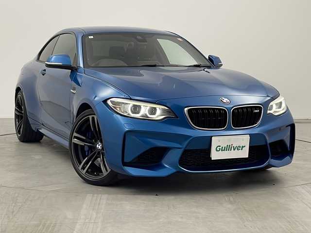 ＢＭＷ Ｍ２ 三重県 2017(平29)年 7万km ロングビーチブルーメタリック 禁煙車/純正HDDナビ/CD/DVD/BT/AUX/バックカメラ/衝突被害軽減ブレーキ/レーンキープアシスト/クルーズコントロール/レザーシート/シートヒーター/ビルトインETC/パドルシフト/オートライト/メモリシート/アイドリングストップ
