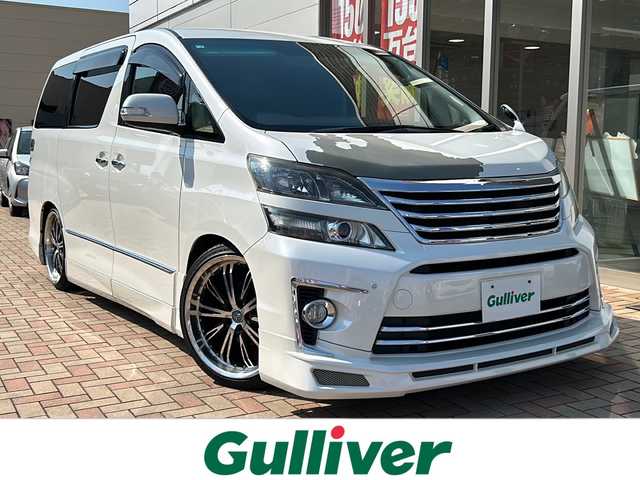 トヨタ ヴェルファイア 2．4Z Gエディション 鳥取県 2012(平24)年 6.7万km ホワイトパールクリスタルシャイン アドミレーションエアロ/社外20インチAW/社外ローダウン/クラジオ革調シートカバー/クラジオフロアマット/社外８インチワイドナビ/社外フリップダウンモニター/フルセグ・Bluetooth/バックカメラ/社外マフラーカッター/スマートキーx2個/両側パワースライド/パワーテールゲート/ウッドコンビハンドル/クルーズコントロール/クリアランスソナー/オートワイパー/オートリトラクトミラー/オートライト/キセノンライト/フォグライト/N席セカンドオットマン/前・セカンドパワーシート/nano-eエアコン/ETCユニット/保証書・取説