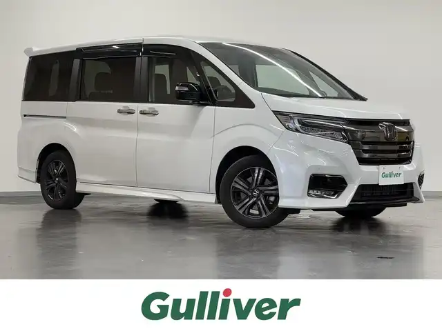 ホンダ ステップワゴン スパーダ eHEV G EXホンダS 三重県 2020(令2)年 2.7万km プラチナホワイトパール ハイブリッド/FF/インパネCVT/純正 9インチナビ VXM-207VFNi/（FM/AM/CD/DVD/TV/SD/Music Rack/USB/iPod/Bluetooth/HDMI/CarPlay）/バックカメラ/両側パワースライドドア/ドライブレコーダー 前後（前方のみナビ連動）/ビルトイン ETC2.0/Honda SENSING/・衝突軽減ブレーキ［CMBS］/・車線維持支援システム［LKAS］/・アダプティブクルーズコントロール［ACC］/・路外逸脱抑制機能/・標識認識機能/・先行車発進お知らせ機能/・パーキングセンサーシステム/装備/・ハーフレザーシート/・シートヒーター（D/N）/・トリプルゾーン・フルオートエアコン（左右＆後席）/・電子パーキングブレーキ＋ブレーキホールド機能/・オートライト/・LED ヘッドライト＋フロントフォグライト/・ステアリングスイッチ/・プッシュスタート/・純正16inAW/・取/ナビ取/・スマートキーx1