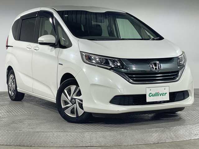 ホンダ フリード ハイブリット G ホンダセンシング 神奈川県 2019(平31)年 7.5万km ホワイトオーキッドパール 純正9型メモリーナビゲーション【VXM-197VFNi】/純正後席フリップダウンモニター/フルセグ　CD DVD　Bluetooth　AM FM SDMUSICRACK　/バックカメラ/両側電動スライドドア【サンシェード】/ホンダセンシング/CMBS衝突軽減ブレーキ/レーンキープアシストシステム/ACC先行車検知機能/レーダークルーズコントロール/先行車発進お知らせ機能/路外逸脱抑制機能/標識認識機能/社外前方ドライブレコーダー/ビルトインETC/ECON/プッシュスタート/スマートキー/LEDヘッドライト/オートライト
