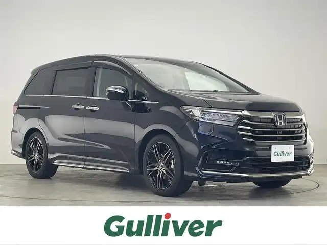 ホンダ オデッセイ ハイブリッド e:HEVアブソルート EX 滋賀県 2021(令3)年 1.6万km プレミアムヴィーナスブラックP 禁煙車/純正ナビ/（CD/DVD/SD/Bluetooth/フルセグTV）/全方位カメラ/純正フリップダウンモニター/ビルトインETC/前後ドライブレコーダー/両側電動スライドドア/パワーバックドア/路外逸脱抑制機能/レーンキープアシストシステム/ブラインドスポットモニター/衝突被害軽減ブレーキ/クリアランスソナー/標識認識機能/電動パーキングブレーキ/オートホールドブレーキ/革巻きステアリング/アダプティブクルーズコントロール/ステアリングリモコン/ハーフレザーシート/前席シートヒーター/前席パワーシート/LEDヘッドライト/フォグランプ/オートヘッドライト/カーテンエアバッグ