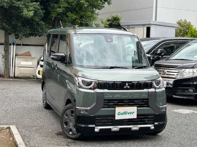 三菱 デリカミニ G 東京都 2024(令6)年 0.1万km 緑 登録時走行215km/e-アシスト（運転支援機能）/・衝突被害軽減ブレーキシステム/・前方衝突予測警報/・踏み間違い衝突防止アシスト/・標識検知システム/・車線逸脱警報システム/・車線逸脱防止支援機能/・先行車発進通知/・オートマチックハイビーム/・ふらつき警報/社外ディスプレイオーディオ/バックカメラ/ハンズフリーパワースライドドア/LEDライト/スマートキー/オートエアコン/保証書・取説/スペアキー