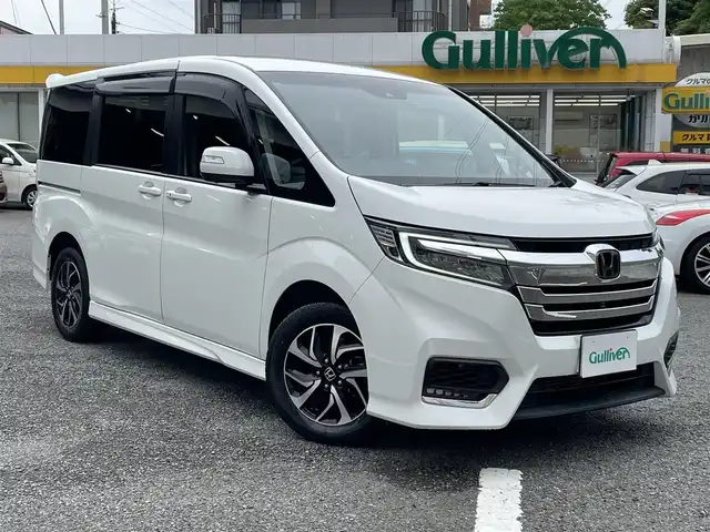 ホンダ ステップワゴン スパーダ ホンダセンシング 神奈川県 2018(平30)年 1.1万km プラチナホワイトパール ワンオーナー /4WD/登録時10493キロ/●ギャザーズ10インチナビVXU-187SWi/CD /DVD /SD /USB /フルセグ/●ナビ連動ドラレコ/●全方位カメラ/●ビルトインETC/●Honda SENSING/衝突軽減ブレーキ〈CMBS〉/誤発進抑制機能/歩行者事故低減ステアリング/路外逸脱抑制機能/ACC〈アダプティブ・クルーズ・コントロール〉/LKAS〈車線維持支援システム〉/先行車発進お知らせ機能/標識認識機能/●LEDヘッドライト/●LEDフォグライト/●本革巻ステアリング/●SPADA専用テールゲートスポイラー/●SPADA専用16インチアルミ/●パドルシフト/●リア両側パワースライドドア/●わくわくゲート/●シートバックテーブル（運転席/助手席）/●ロールサンシェイド/●サイドエアバッグ/●サイドカーテンエアバッグ/スマートキー×2/新車時保証書/取扱説明書/ナビ取扱説明書