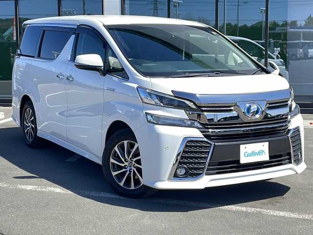 トヨタ ヴェルファイア ハイブリット ZR 道東・釧路十勝 2016(平28)年 10.3万km ホワイトパールクリスタルシャイン ・４WD/・アルパインビックX11型ナビ/【CD/DVD/フルセグ.BT.SD.FM/AM】/・アルパイン１２.８型フリップダウンモニター/・バックカメラ/・ETC/・両側パワースライドドア/・ハーフレザーシート/・パワーバックドア/・クルーズコントロール/・前席パワーシート/・LEDヘッドライト/・フォグライト/・横滑り防止/・本革巻きステアリング/・ステアリングスイッチ/・社外アルミ冬タイヤ積込/・純正エンジンスターター/・コーナーセンサー/・ユピテルレーダー/・保証書・取説
