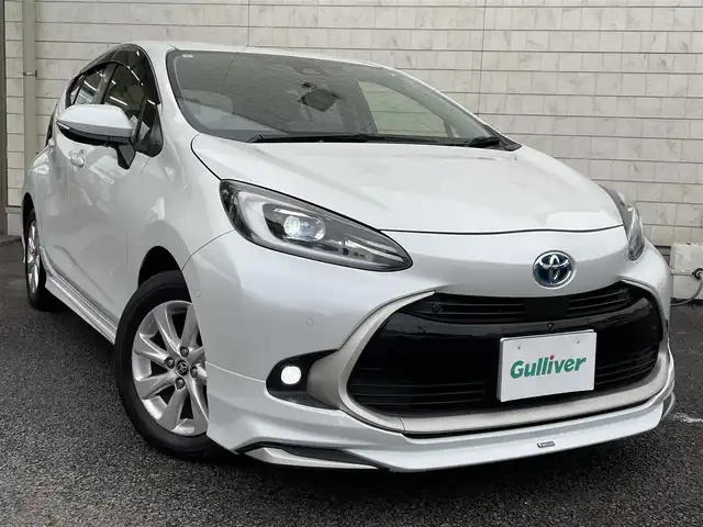 トヨタ アクア Z 大分県 2021(令3)年 2.8万km プラチナホワイトパールマイカ モデリスタエアロ/メーカーナビ 【BTオーディオ】/全方位カメラ/ハーフレザー調シート/純正15インチアルミホイール/レーンアシスト/プリクラッシュセーフティ/レーダークルーズコントロール/パーキングアシスト/クリアランスソナー/充電用USBソケット（Cタイプ）/AC100V電源/運転席パワーシート/前席シートヒーター/LEDヘッドライト/LEDフォグランプ/オートライト/オートマチックハイビーム/ヘッドライトレベライザー/レザーステアリング/ステアリングヒーター/ステアリングリモコン/チルトステアリング/ウインカーミラー/エンジンプッシュスタート/リアプライバシーガラス/横滑り防止装置/ドアバイザー/フロアマット/オートリトラミラー/サイド＆Wエアバッグ/ABS/スマートキー×2/保証書/車両取説/ナビ取説