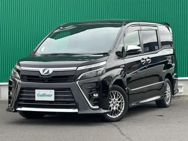 トヨタ ヴォクシー ハイブリッド ZS 煌 宮城県 2018(平30)年 6.8万km ブラック セーフティセンス/・プリクラッシュセーフティ/・レーンディパーチャーアラート/・オートマチックハイビーム/・先行車発進告知機能/純正9インチナビ（NSZT-Y66T）/・CD/DVD/・Bluetooth/・フルセグTV/バックカメラ/ビルトインETC/前席シートヒーター/両側パワースライドドア/革巻きステアリング/クルーズコントロール/ステアリングスイッチ/LEDヘッドランプ/フォグランプ/オートライト/スマートキー＆プッシュスタート/電動格納ミラー/純正16インチAW/純正フロアマット/純正ドアバイザー/Wエアバッグ