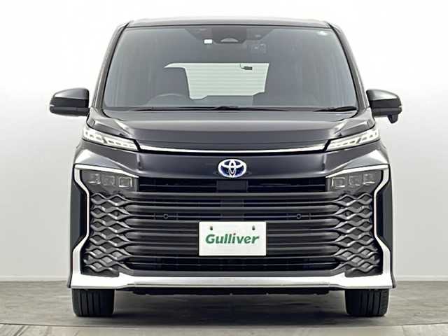 トヨタ ヴォクシー ハイブリッド S－Z 大阪府 2022(令4)年 1.4万km グリッターブラックガラスフレーク 純正10.5incディスプレイオーディオナビ/【フルセグTV/Bluetooth/HDMI/FM/AM/USB】/快適利便パッケージ(High)/・両側ハンズフリーパワースライドドア/・パワーバックドア/・前後シートヒーター/・ステアリングヒーター/・後席オットマン/・nanoe/3眼LEDヘッドライト/ブラインドスポットモニター/AC100Vコンセント/トヨタセーフティセンス/・レーダークルーズコントロール/・プリクラッシュセーフティー/・パーキングサポートブレーキ/・レーンディパーチャーアラート/・オートマチックハイビーム/・ロードサインアシスト/・ドライバー異常対応システム/オートホールド/前後コーナーセンサー/半革シート/後席サンシェード/ISOFIX