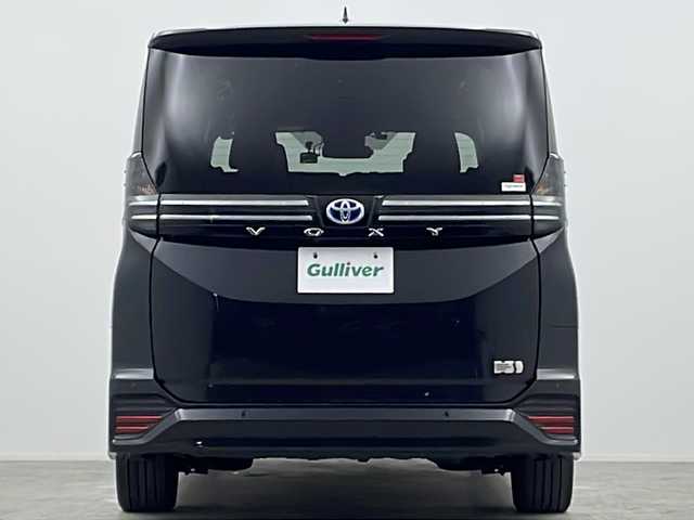 トヨタ ヴォクシー ハイブリッド S－Z 大阪府 2022(令4)年 1.4万km グリッターブラックガラスフレーク 純正10.5incディスプレイオーディオナビ/【フルセグTV/Bluetooth/HDMI/FM/AM/USB】/快適利便パッケージ(High)/・両側ハンズフリーパワースライドドア/・パワーバックドア/・前後シートヒーター/・ステアリングヒーター/・後席オットマン/・nanoe/3眼LEDヘッドライト/ブラインドスポットモニター/AC100Vコンセント/トヨタセーフティセンス/・レーダークルーズコントロール/・プリクラッシュセーフティー/・パーキングサポートブレーキ/・レーンディパーチャーアラート/・オートマチックハイビーム/・ロードサインアシスト/・ドライバー異常対応システム/オートホールド/前後コーナーセンサー/半革シート/後席サンシェード/ISOFIX