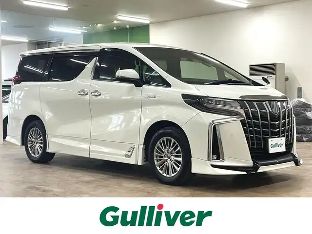 トヨタ アルファードハイブリット SR 道央・札幌 2019(平31)年 8.9万km ラグジュアリーホワイトパールクリスタルシャインガラスフレーク ワンオーナー/4WD/寒冷地仕様/OP　TRDエアロ（フロント/サイド/リア）/OP　TRD4本出しマフラー/ALPINE　11型ナビ/フルセグ/Bluetooth/CD/DVD/SD/HDMI/ALPINE　12.8型フリップダウンモニター/衝突軽減ブレーキ/レーンキープアシスト/横滑り防止/両側パワースライドドア/パワーバックドア/レーダークルーズコントロール/三眼LEDヘッドライト/シーケンシャルウィンカー/黒革シート/パワーシート（D/N）/エアーシート（D/N）/シートヒーター（D/N）/スマートキー×2/純正エンジンスターター/フロントワイパーデアイサー/コムテック前後ドラレコ/オートマチックハイビーム/保証書/取扱説明書