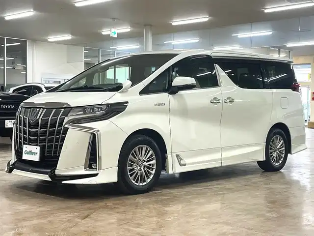 トヨタ アルファードハイブリット SR 道央・札幌 2019(平31)年 8.9万km ラグジュアリーホワイトパールクリスタルシャインガラスフレーク ワンオーナー/4WD/寒冷地仕様/OP　TRDエアロ（フロント/サイド/リア）/OP　TRD4本出しマフラー/ALPINE　11型ナビ/フルセグ/Bluetooth/CD/DVD/SD/HDMI/ALPINE　12.8型フリップダウンモニター/衝突軽減ブレーキ/レーンキープアシスト/横滑り防止/両側パワースライドドア/パワーバックドア/レーダークルーズコントロール/三眼LEDヘッドライト/シーケンシャルウィンカー/黒革シート/パワーシート（D/N）/エアーシート（D/N）/シートヒーター（D/N）/スマートキー×2/純正エンジンスターター/フロントワイパーデアイサー/コムテック前後ドラレコ/オートマチックハイビーム/保証書/取扱説明書