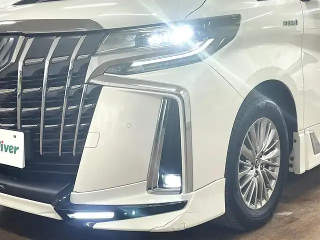 トヨタ アルファードハイブリット SR 道央・札幌 2019(平31)年 8.9万km ラグジュアリーホワイトパールクリスタルシャインガラスフレーク ワンオーナー/4WD/寒冷地仕様/OP　TRDエアロ（フロント/サイド/リア）/OP　TRD4本出しマフラー/ALPINE　11型ナビ/フルセグ/Bluetooth/CD/DVD/SD/HDMI/ALPINE　12.8型フリップダウンモニター/衝突軽減ブレーキ/レーンキープアシスト/横滑り防止/両側パワースライドドア/パワーバックドア/レーダークルーズコントロール/三眼LEDヘッドライト/シーケンシャルウィンカー/黒革シート/パワーシート（D/N）/エアーシート（D/N）/シートヒーター（D/N）/スマートキー×2/純正エンジンスターター/フロントワイパーデアイサー/コムテック前後ドラレコ/オートマチックハイビーム/保証書/取扱説明書