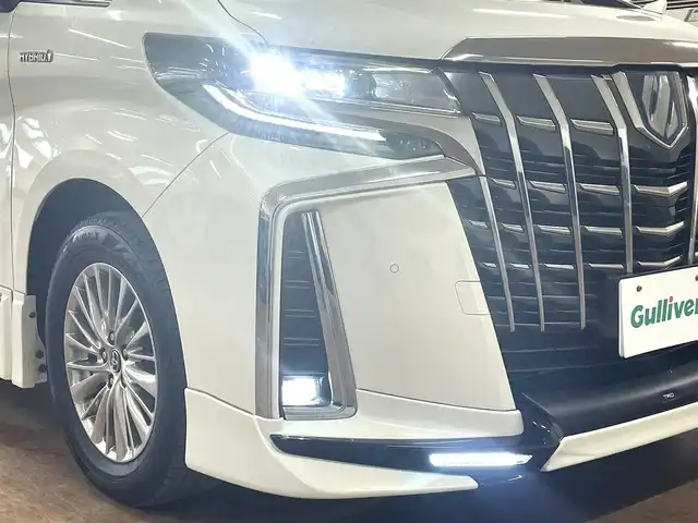 トヨタ アルファードハイブリット SR 道央・札幌 2019(平31)年 8.9万km ラグジュアリーホワイトパールクリスタルシャインガラスフレーク ワンオーナー/4WD/寒冷地仕様/OP　TRDエアロ（フロント/サイド/リア）/OP　TRD4本出しマフラー/ALPINE　11型ナビ/フルセグ/Bluetooth/CD/DVD/SD/HDMI/ALPINE　12.8型フリップダウンモニター/衝突軽減ブレーキ/レーンキープアシスト/横滑り防止/両側パワースライドドア/パワーバックドア/レーダークルーズコントロール/三眼LEDヘッドライト/シーケンシャルウィンカー/黒革シート/パワーシート（D/N）/エアーシート（D/N）/シートヒーター（D/N）/スマートキー×2/純正エンジンスターター/フロントワイパーデアイサー/コムテック前後ドラレコ/オートマチックハイビーム/保証書/取扱説明書