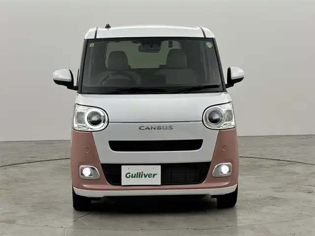 ダイハツ ムーヴ キャンバス ストライプス G 福岡県 2022(令4)年 0.7万km シャイニングホワイトパール/アプリコットピンクメタリック 純正ナビ／フルセグＴＶ　/バックカメラ　/ホッとカップホルダー　/ＥＴＣ　/ドラレコ　/コーナーセンサー　/スマートアシスト　/衝突軽減ブレーキ　/レーンキープ　/アイドリングストップ　/両側電動スライドドア　/シートヒーター　/ＬＥＤヘッドライト