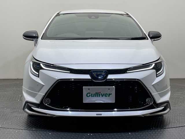トヨタ カローラツーリング ハイブリッド ダブルバイビー 愛媛県 2020(令2)年 1.3万km ホワイトパールクリスタルシャイン 純正ナビ/Ｂｌｕｅｔｏｏｔｈ／ＵＳＢ/バックカメラ/衝突軽減ブレーキ/レーダークルーズコントロール/ＥＴＣ２．０/全方位ドライブレコーダー/モデリスタエアロ/前後コーナーセンサー/レーンキープアシスト/オートマチックハイビーム/LEDヘッドライト