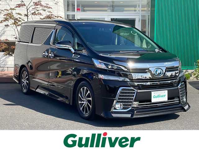 トヨタ ヴェルファイア ハイブリット ZR 青森県 2015(平27)年 6.8万km バーニングブラッククリスタルシャインガラスフレーク 4WD/OP寒冷地仕様/OP JBLプレミアムサウンド/OPリアエンターテイメントシステム/純正9.2インチTコネクトナビ・フルセグTV/CD・DVD・Bluetooth・SD・USB/12.1インチ純正フリップダウンモニター/OPパノラミックビューモニター/OPプリクラッシュセーフティ/OPレーダークルーズ/OPインテリジェントクリアランスソナー/OPパワーバックドア/両側パワースライドドア/合皮コンビシート/前席パワーシート/助手席パワーオットマン/スマートキー一体式エンジンスターター/OP AC100V1500W/社外ドライブレコーダー/ETC/ワイパーデアイサー/LEDヘッドライト/LEDフォグランプ/LEDリアフォグランプ/純正17インチアルミ/アンダーエアロ/TEIN車高調/スマートキー/スペアキー/保証書・取説書