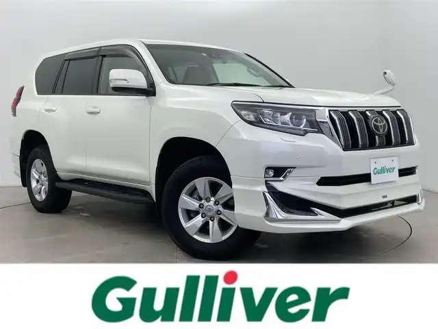 トヨタ ランドクルーザー プラド TX Lパッケージ 富山県 2023(令5)年 2.1万km ホワイトパールクリスタルシャイン サンルーフ/モデリスタエアロ/純正ナビ（AM/FM/DVD/BT/フルセグ）/バックカメラ/ドライブレコーダー/ETC/レザーシート/D/N席パワーシート/D/N席シートヒーター/D/N席シートベンチレーション/衝突被害軽減システム/レーダークルーズコントロール/レーンキープアシスト/コーナーセンサー/横滑り防止装置/純正アルミホイール/純正フロアマット/革巻きステアリング/ステアリングスイッチ/スマートキー