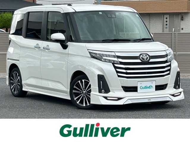 トヨタ ルーミー カスタムG－T 千葉県 2022(令4)年 2.8万km パールホワイトⅢ 純正ディスプレイオーディオ/フルセグTV/Bluetooth/パノラミックビューモニター/モデリスタエアロ（フロント・サイド・リア）/前後コーナーセンサー/両側パワースライドドア/レーダークルーズコントロール/前席シートヒーター/スマートアシスト３/衝突警報機能/衝突回避支援ブレーキ機能/誤発進抑制制御機能/車線逸脱警報機能/車線逸脱抑制制御機能/路側逸脱警報機能/ふらつき警報/先行車発進お知らせ/標識認識機能/レーンキープコントロール/リヤクロストラフィックアラート/オートハイビーム/ウィンカーミラー/プッシュスタート/スマートキー/電動パーキングブレーキ/オートホールドブレーキ/LEDヘッドライト/純正アルミホイール/純正フロアマット