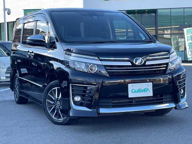 トヨタ ヴォクシー ZS 煌Ⅱ 長野県 2016(平28)年 6万km ブラック 禁煙車/アルパインナビ/CD/DVD/Bluetooth/フルセグTV/バックカメラ/アルパインフリップダウンモニター/両側パワースライドドア/アイドリングストップ/ETC/純正AW16インチ/横滑り防止装置/レーンキープアシスト/衝突軽減ブレーキ/オートマチックハイビーム/革巻きステアリング/ウォークスルー/ドアバイザー/プッシュスタート/スマートキー/スペアキー