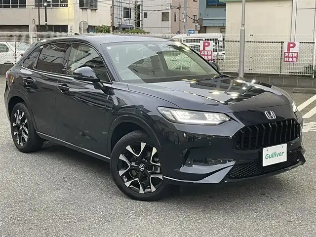 ホンダ ＺＲ－Ｖ ハイブリッド e:HEV Z 神奈川県 2024(令6)年 0.9万km ミッドナイトブルービームM ワンオーナー/４WD/Honda SENSING/・衝突軽減ブレーキ/・踏み間違い衝突軽減システム/・路外逸脱抑制機能/・歩行者事故低減ステアリング/・先行車発進お知らせ機能/・標識認識機能/・オートハイビーム/・アダプティブドライビングビーム/・ブラインドスポットインフォメーション/・後退出庫サポート/・パーキングセンサーシステム/・アダプティブクルーズコントロール/・車線逸脱支援システム/・トラフィックジャムアシスト/Honda CONNECTディスプレイ/・ナビ機能/スマホ連動/フルセグTV/BT//マルチビューカメラシステム/ビルトインETC2.0/革シート/・全席シートヒーター/・前席パワーシート/・D席メモリシート/パドルシフト/ステアリングリモコン/置くだけ充電/前後ドライブレコーダー/パワーテールゲート/純正１８inアルミホイール/オートライト/LEDライト/ウインカー付電格ミラー/電動パーキングブレーキ/ブレーキホールド/W＆サイド＆カーテンエアバック/横滑り防止装置/ヒルディセントコントロール/フロアマット/保証書/取扱説明書/スペアキー