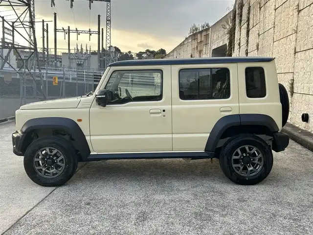 スズキ ジムニー ノマド FC 長崎県 2025(令7)年 0.3万km ベージュⅡ ワンオーナー/衝突軽減システム/レーンアシスト/レーダークルーズ/シートヒーター/スマートキー/プッシュスタート/電動格納ミラー/アイドリングストップ/純正15インチAW