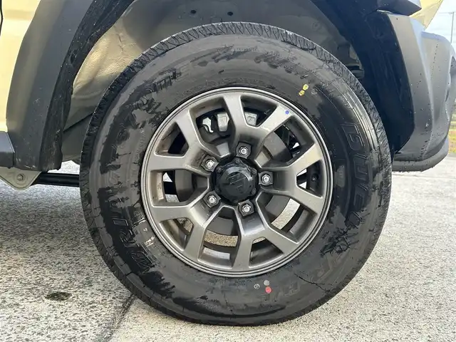 スズキ ジムニー ノマド FC 長崎県 2025(令7)年 0.3万km ベージュⅡ ワンオーナー/衝突軽減システム/レーンアシスト/レーダークルーズ/シートヒーター/スマートキー/プッシュスタート/電動格納ミラー/アイドリングストップ/純正15インチAW