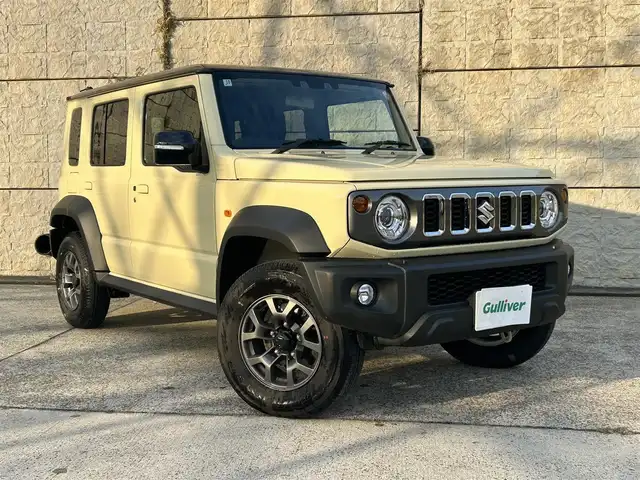 スズキ ジムニー ノマド FC 長崎県 2025(令7)年 0.3万km ベージュⅡ ワンオーナー/衝突軽減システム/レーンアシスト/レーダークルーズ/シートヒーター/スマートキー/プッシュスタート/電動格納ミラー/アイドリングストップ/純正15インチAW