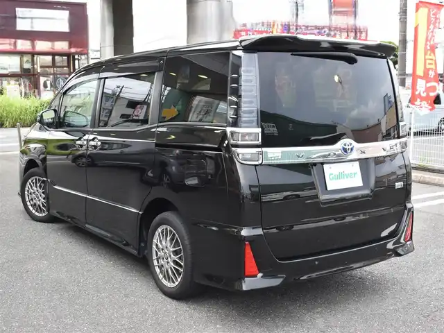 トヨタ ヴォクシー ハイブリッド ZS 煌Ⅲ 福岡県 2021(令3)年 4.6万km イナズマスパーキングブラックガラスフレーク トヨタセーフティセンス/純正9インチメモリーナビ/純正後席フリップダウンモニター/フルセグTV/CD/DVD/BT/バックカメラ/純正前後ドライブレコーダー/純正LEDヘッドライト/純正16インチアルミホイール/両側パワースライドドア/クルーズコントロール/ハーフレザーシート/前席シートヒーター/クリアランスソナー/ビルトインETC/プッシュスタート/スマートキー×2/新車時保証所/取扱説明書