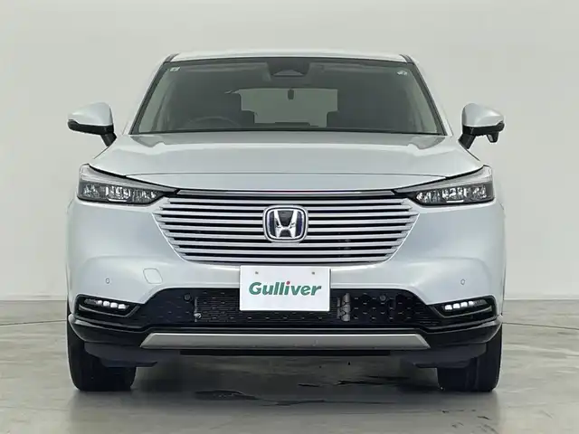 ホンダ ヴェゼル ハイブリッド e:HEV Z 群馬県 2021(令3)年 6万km プレミアムサンライトホワイトパール サイドステップガーニッシュ/置くだけ充電/パドルシフト/カーテンエアバッグ/===============/ワンオーナー/ホンダセンシング/　・衝突軽減ブレーキ/　・先行車発進お知らせ機能/　・路外逸脱抑制機能/　・標識認識機能/　・アダプティブクルーズコントロール/　・車線維持支援システム/　・トラフィックジャムアシスト/　・ブラインドスポットインフォメーション/　・誤発進抑制機能/　・後退出庫サポート/　・オートハイビーム/Honda Conected　9インチディスプレイ/　FM/AM/Bluetooth/TV/バックカメラ/前後ドライブレコーダー/ハンズフリーアクセスパワーテールゲート/ダウンヒルコントロール/前後コーナーセンサー/前席シートヒーター/純正18インチAW/純正フロアマット/スペアキー/保証書/取扱説明書