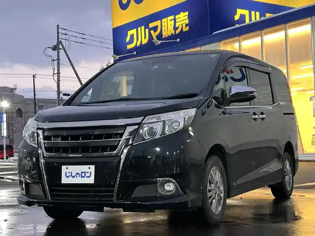 トヨタ エスクァイア Gi ブラックテーラード 道北・旭川 2016(平28)年 13万km ブラック (株)IDOMが運営する【じしゃロン旭川店】の自社ローン対象車両になります。こちらは現金ご利用時の価格です。自社ローンご希望の方は別途その旨お申付け下さい。/　/・純正ナビ(CD/DVD/BT/SD/フルセグ)/・バックカメラ/・ETC/・ドライブレコーダー/・レーダーブレーキ/・クルーズコントロール/・両側パワースライドドア/・両席シートヒーター/・電動格納ウィンカーミラー/・プッシュスタート/・スマートキー2個/・フォグランプ/・現車装着サマータイヤ 純正AW195/65R15