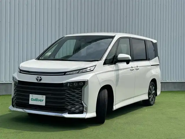トヨタ ヴォクシー S－Z 香川県 2024(令6)年 1.4万km ホワイトパールクリスタルシャイン トヨタセーフティーセンス/・プリクラッシュ/・LTA/純正10.5型ナビ/バックカメラ/両側パワースライドドア/ハーフレザーシート/シートヒーター/革巻きステアリング/ステアリングリモコン/レーダークルーズ/電動パーキング/オートホールド/サンシェード/スマートキー/プッシュスタート