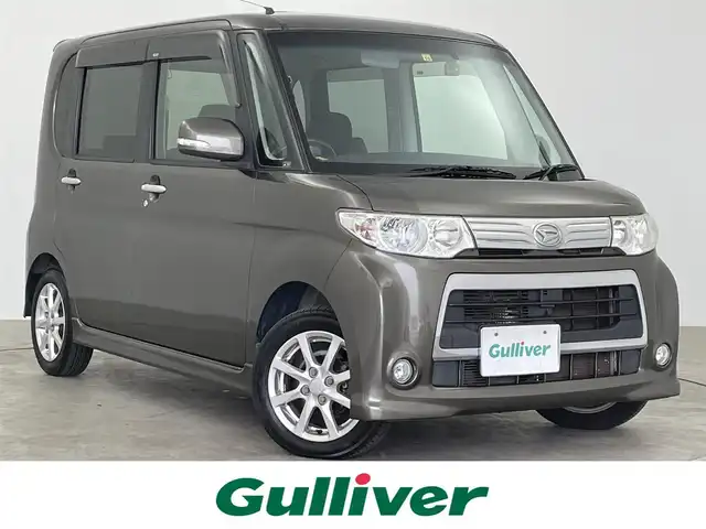 ダイハツ タント カスタム X 大分県 2010(平22)年 6.8万km ブロンズオリーブパールメタリック 社外７型ナビ/（Ｂｌｕｅｔｏｏｔｈ／ＣＤ／ＤＶＤ／ＳＤ／フルセグＴＶ）/バックカメラ/ＥＴＣ/スマートキー/社外ドラレコ前後/電動格納ウィンカーミラー/ドアバイザー/フォグランプ/純正アルミホイール/片側パワースライドドア