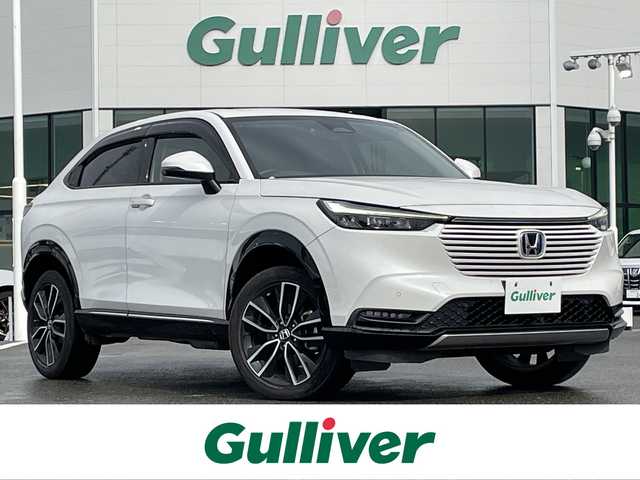 ホンダ ヴェゼル ハイブリッド e:HEV Z 佐賀県 2021(令3)年 6.7万km プラチナホワイトパール ワンオーナー/純正9インチナビゲーション・フルセグ/Bluetooth・USB・Applecarplay・androidaudio/バックカメラ/ビルトイン2.0ETC/パワーバックドア/置くだけ充電/AUTOHOLD/電子パーキング/ハーフレザーシート/シートヒーター/フルフラットシート/チップアップシート/革巻きステアリング/ステアリングヒーター/ステアリングリモコン/純正LEDシーケンシャルウィンカー/純正LEDヘッドライト/純正18インチアルミホイール/純正フロアマット/純正ドアバイザー/ホンダセンシング/・衝突軽減ブレーキ/・誤発進抑制機能/・歩行者事故低減ステアリング/・アダプティブクルーズコントロール/・路外逸脱抑制機能/・標識認識機能/・先行車発進お知らせ機能/・ブラインドスポットインフォメーション/・パーキングセンサーシステム/・緊急時停車支援機能